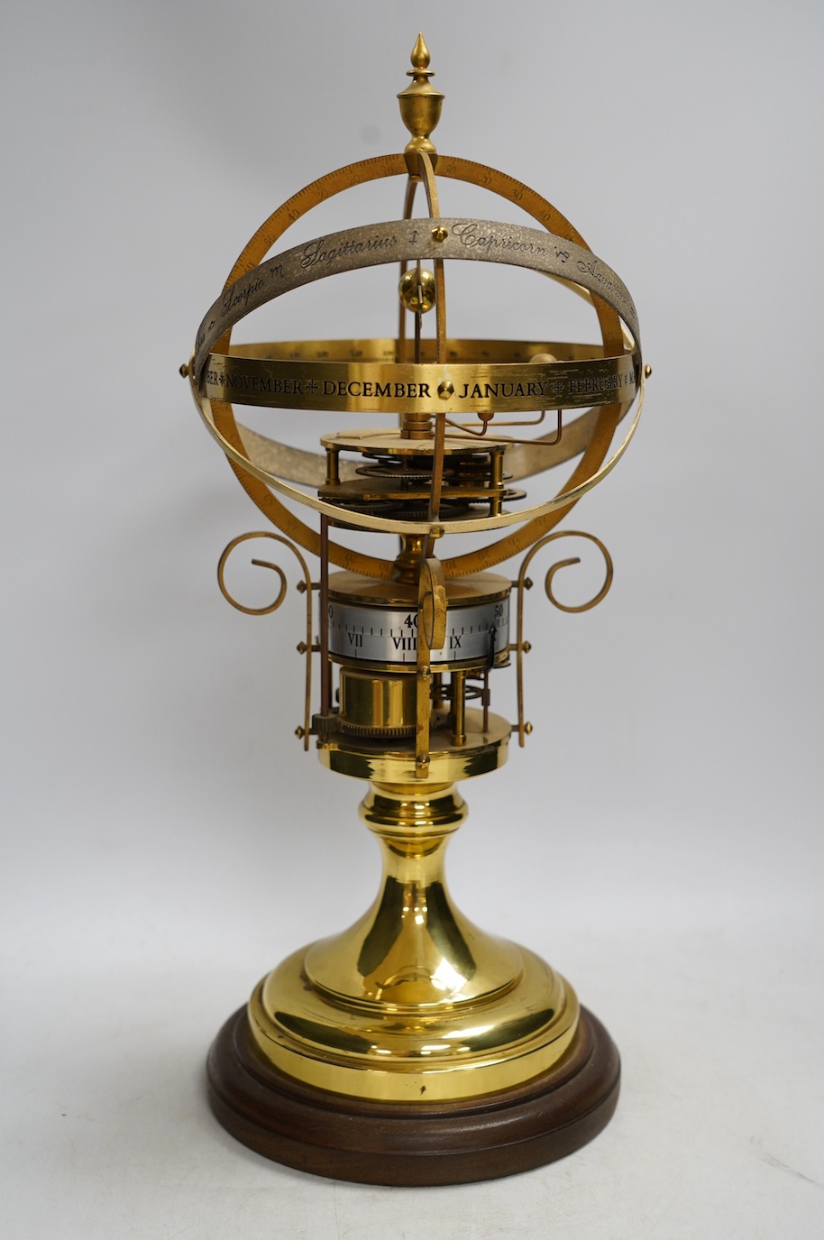 A modern clockwork armillary sphere, engraved St. James’s House Co. London, 44cm high, with two related books. Condition - fair, some discolouration to the metal work and general wear.